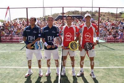 Players engaging in an international Padel match, spectators in the background